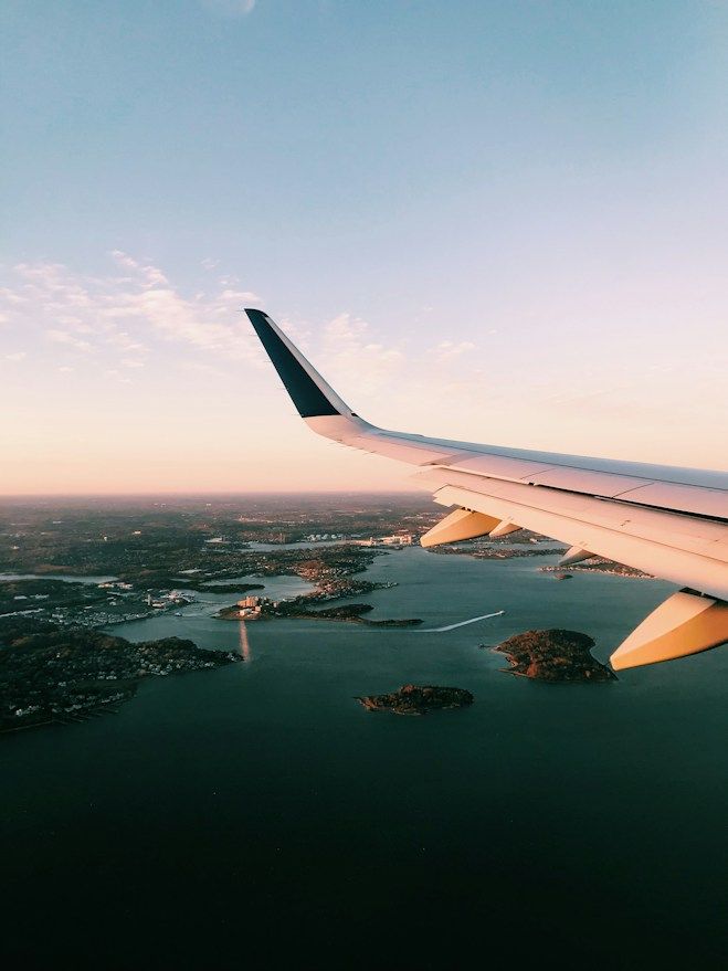 View from an airplane window over the coast at sunset